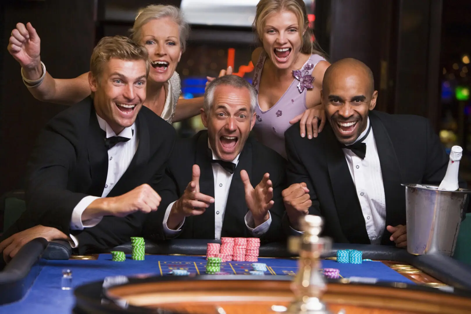 A group of people in suits and ties at a casino.