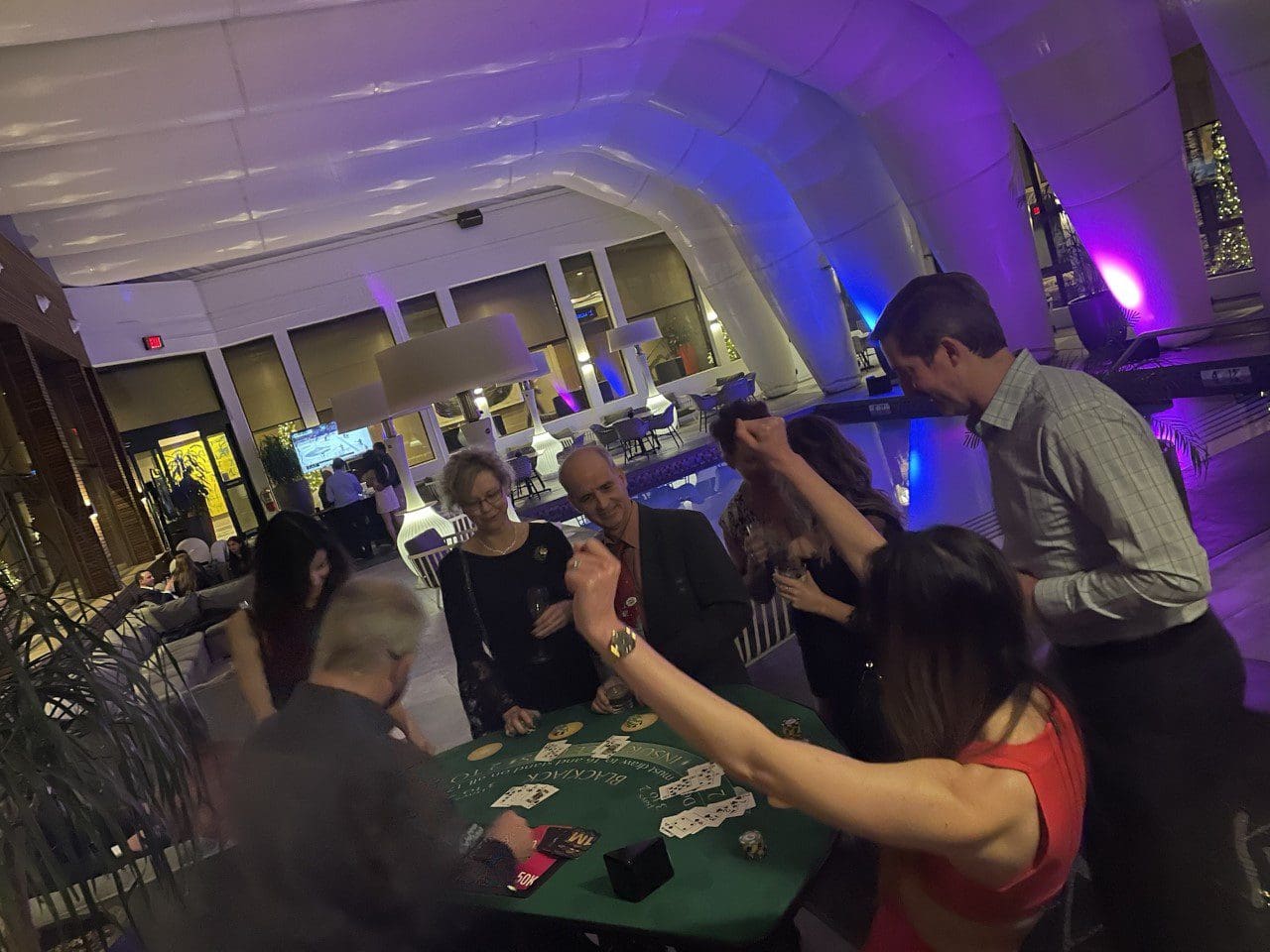 A group of people playing cards at an event.