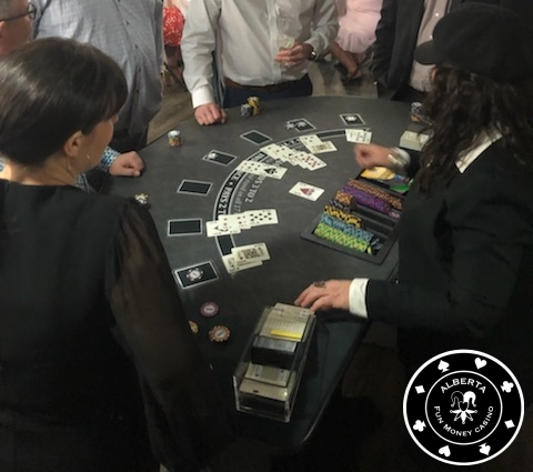 A group of people playing cards at a table.