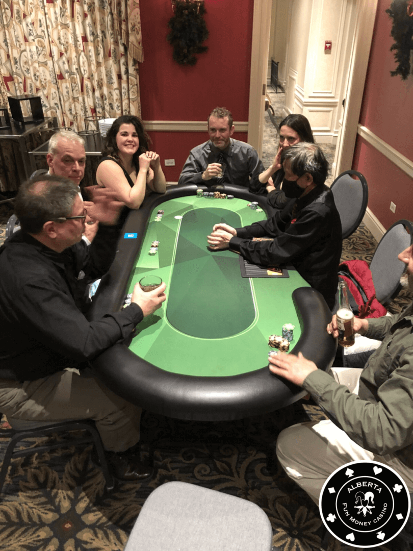 A group of people sitting around a table with cards.