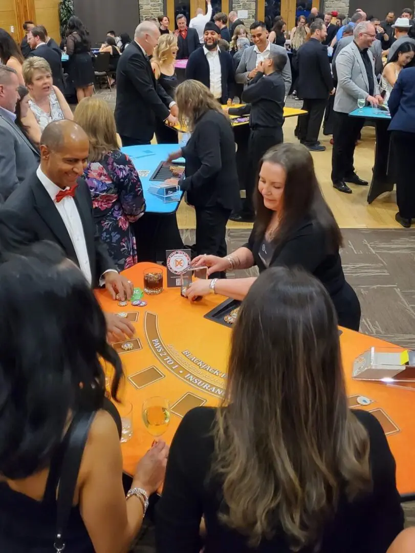 A group of people standing around a table.