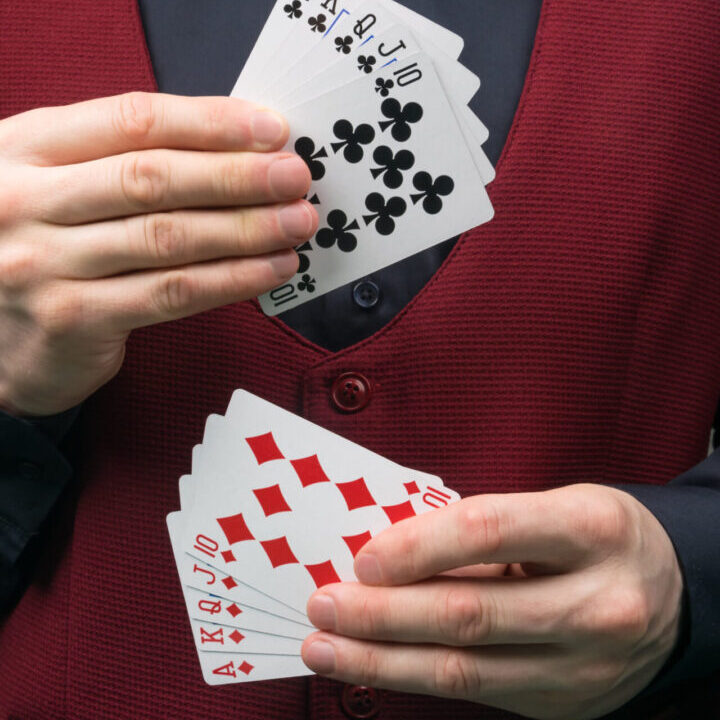 A man holding cards in his hands